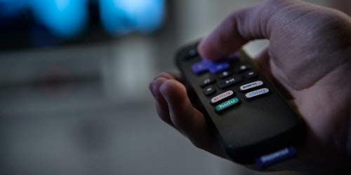 A consumer using a smart television to stream entertainment A consumer using a smart television to stream entertainment