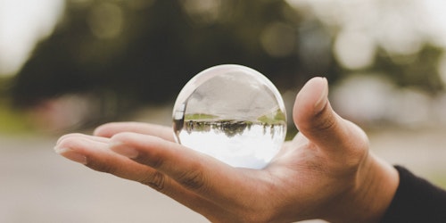 A hand holding a clear orb A hand holding a clear orb