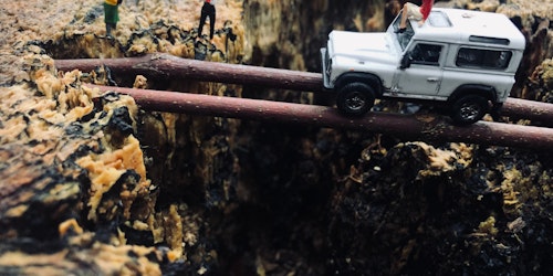 Lego figures acting out a dangerous tree-trunk-bridge crossing by a jeep Lego figures acting out a dangerous tree-trunk-bridge crossing by a jeep
