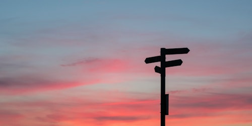 A signpost against a gradient sunset sky A signpost against a gradient sunset sky