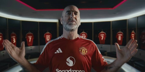 Eric Cantona in the new Manchester United shirt with Snapdragon logo on front Eric Cantona in the new Manchester United shirt with Snapdragon logo on front