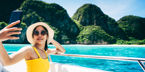 A travel influencer takes a photo of her travels A travel influencer takes a photo of her travels