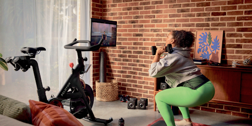 Woman works out with Peloton products Woman works out with Peloton products