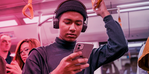 Man holding a rail on the subway - pink purple hue Man holding a rail on the subway - pink purple hue