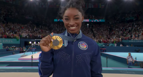 Simone Biles holds up a gold medal at the 2024 Paris Olympics Simone Biles holds up a gold medal at the 2024 Paris Olympics
