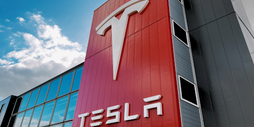 Tesla signage on the outside of a factory Tesla signage on the outside of a factory