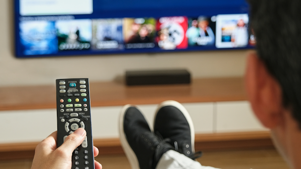 guy with remote control sitting in front of TV guy with remote control sitting in front of TV