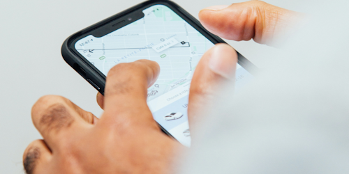 Hands using Uber app Hands using Uber app