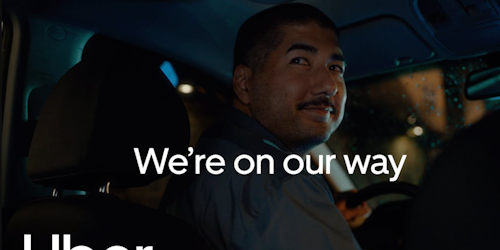 Uber driver with the words 'On our way' on top Uber driver with the words 'On our way' on top